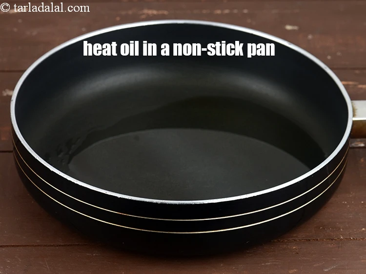 Step 5 – <p><span style="background-color:rgb(255,255,255);color:rgb(0,0,0);"><strong>For the tomato chutney</strong>,&nbsp;heat 2 tbsp.&nbsp;</span><a href="https://www.tarladalal.com/glossary-oil-671i"><u>oil</u></a><span style="background-color:rgb(255,255,255);color:rgb(0,0,0);"> in a non-stick pan.</span></p>