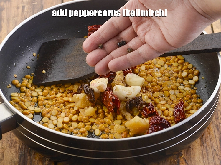Step 11 – <p>Furthermore, add the <span style="background-color:rgb(255,255,255);color:rgb(0,0,0);">4 </span><a href="https://www.tarladalal.com/glossary-peppercorns-584i"><u>peppercorns (kalimirch)</u></a>.</p>