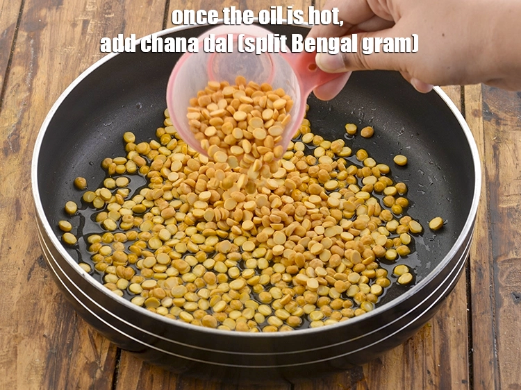 Step 3 – <p><strong>Once the oil is hot</strong>, add the <span style="background-color:rgb(255,255,255);color:rgb(0,0,0);">1/2 cup </span><a href="https://www.tarladalal.com/glossary-chana-dal-split-Bengal-gram-285i"><u>chana dal (split Bengal …