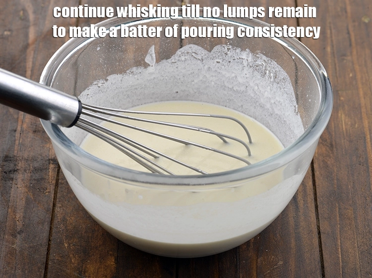 Step 8 – <p>Continue whisking till no lumps remain to make a batter of pouring consistency.</p>