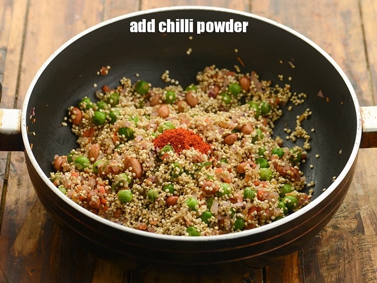 Step 26 – <p>Add <span style="background-color:rgb(255,255,255);color:rgb(0,0,0);">1/4 tsp </span><a href="https://www.tarladalal.com/glossary-chilli-powder-red-chilli-powder-339i"><u>chilli powder</u></a> to spice up <strong>quinoa upma</strong>.</p>