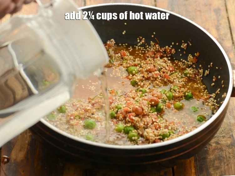 Step 28 – <p>Finally add 2¼ cups of <strong>hot water</strong> for cooking <strong>healthy vegetable quinoa upma</strong>.</p>