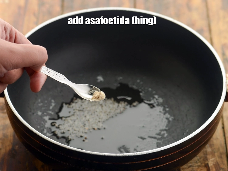 Step 12 – <p>Add the <span style="background-color:rgb(255,255,255);color:rgb(0,0,0);">1/4 tsp </span><a href="https://www.tarladalal.com/glossary-asafoetida-hing-113i"><u>asafoetida (hing)</u></a> and <strong>sauté</strong> on a medium flame for …