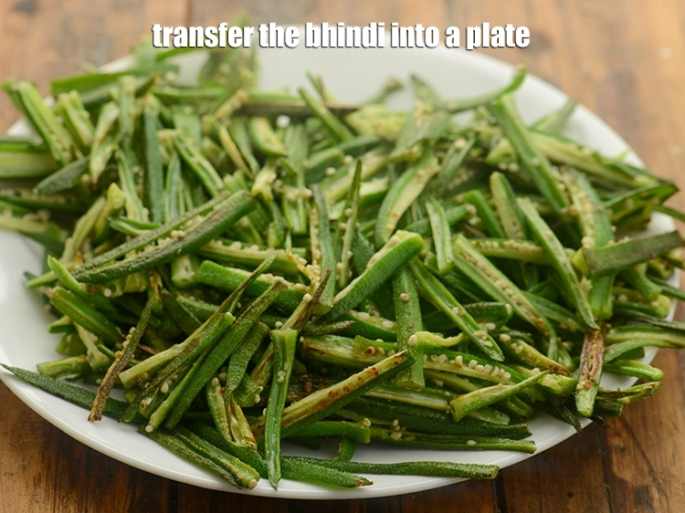 Step 10 – <p>Transfer the <strong>bhindi</strong> into a plate and keep <span style="background-color:rgb(255,255,255);color:rgb(0,0,0);">aside.</span></p>