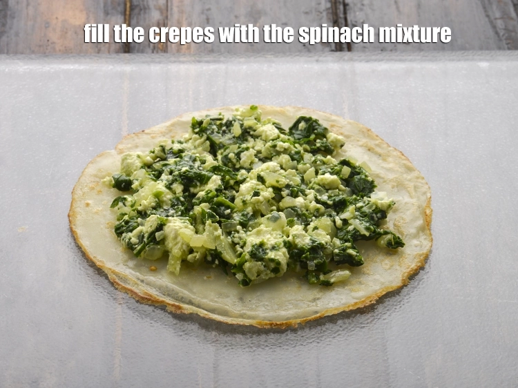 Step 7 – <p><span style="background-color:rgb(255,255,255);color:rgb(0,0,0);">To make the <strong>Spinach Crepes</strong>, fill the <strong>crepes</strong> with the <strong>spinach mixture.</strong></span></p>