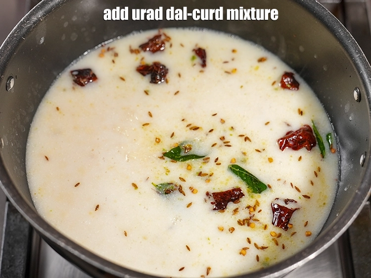 Step 25 – <p><span style="background-color:rgb(255,255,255);color:rgb(0,0,0);">Add the <strong>urad dal-curd mixture</strong>.</span></p>