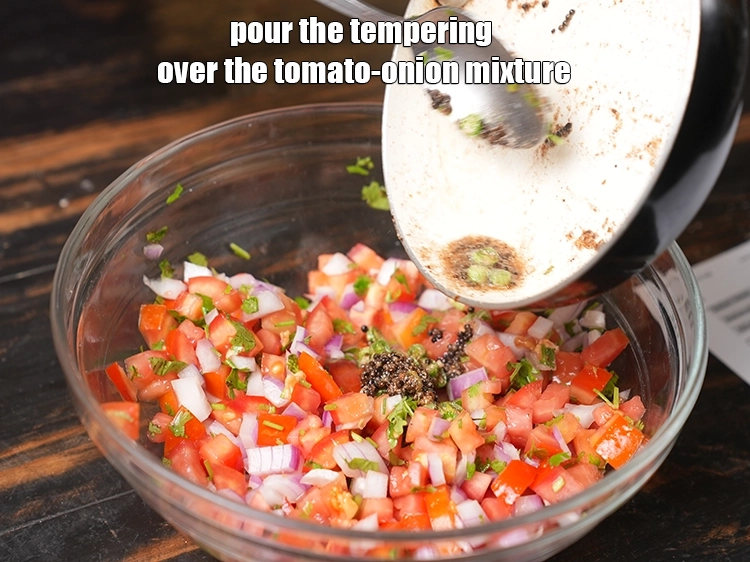 Step 13 – <p>Pour the tempering over the <strong>tomato-onion mixture</strong>.</p>