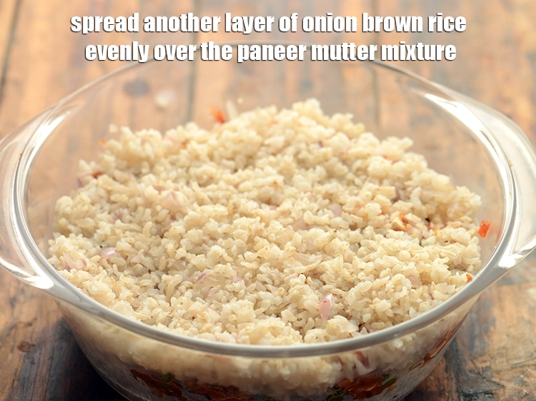Step 32 – <p><strong>Spread</strong> another layer of <strong>onion brown rice</strong> evenly over the <strong>paneer mutter mixture</strong>.</p>
