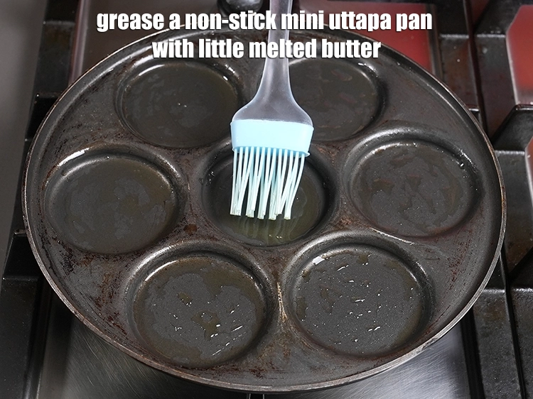 Step 6 – <p><span style="background-color:rgb(255,255,255);color:rgb(0,0,0);">Grease a non-stick <strong>mini uttapa pan</strong> with little </span><a href="https://www.tarladalal.com/glossary-butter-makhan-233i#ing_3123"><u>melted butter</u></a><u>.</u></p>