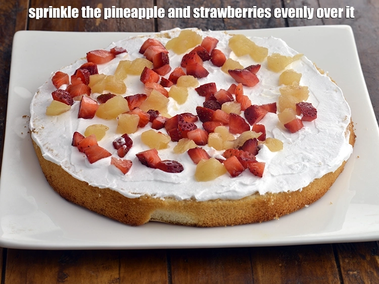 Step 10 – <p><span style="background-color:rgb(255,255,255);color:rgb(0,0,0);">Sprinkle the </span><a href="https://www.tarladalal.com/glossary-pineapple-ananas-88i#ing_2989"><u>chopped pineapple</u></a><span style="background-color:rgb(255,255,255);color:rgb(0,0,0);"> and </span><a href="https://www.tarladalal.com/glossary-strawberry-strawberries-436i#ing_3013"><u>chopped strawberries</u></a><span style="background-color:rgb(255,255,255);color:rgb(0,0,0);"> evenly over it.</span></p>