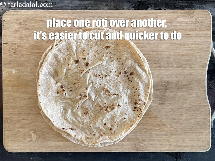 Step 4 – <p>Place one roti over the other so that it's easier to roll and cut.</p>
