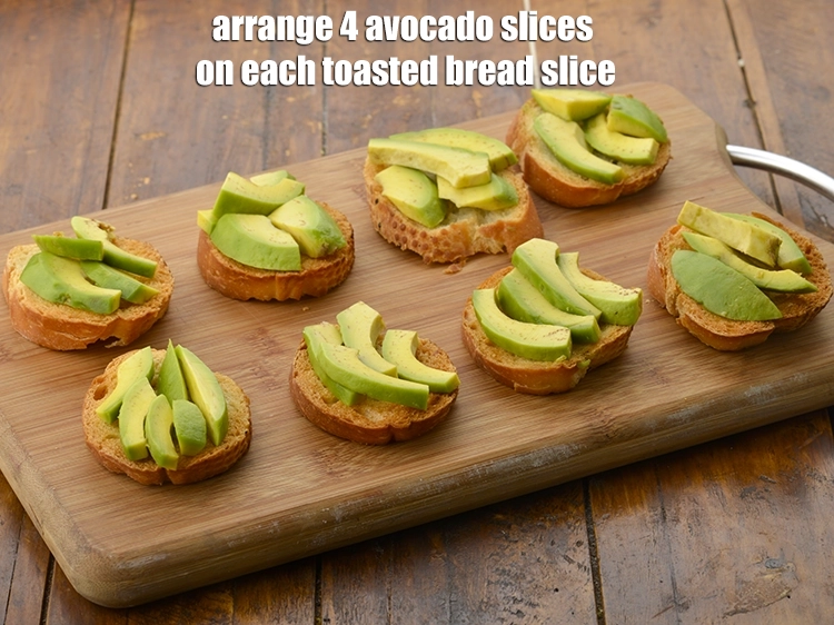 Step 6 – <p><span style="background-color:rgb(255,255,255);color:rgb(0,0,0);"><strong>Cool completely</strong> and arrange 4 </span><a href="https://www.tarladalal.com/glossary-avocado-makhanphal-134i#ing_2995"><u>sliced avocado</u></a><span style="background-color:rgb(255,255,255);color:rgb(0,0,0);"> on each toasted bread slice.</span></p>