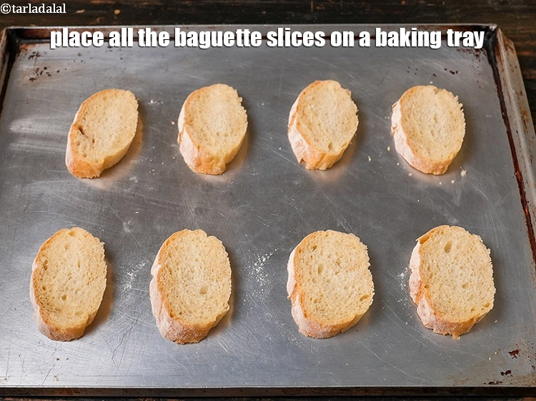 Step 3 – <p><span style="background-color:rgb(255,255,255);color:rgb(0,0,0);">Place the <strong>french bread slices </strong>on a greased <strong>baking tray</strong>.</span></p>