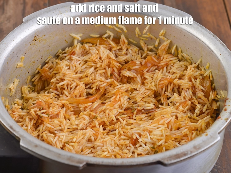 Step 13 – <p><span style="background-color:rgb(255,255,255);color:rgb(0,0,0);">Add the <strong>rice</strong> and </span><a href="https://www.tarladalal.com/glossary-salt-namak-table-salt-418i"><u>salt </u></a><span style="background-color:rgb(255,255,255);color:rgb(0,0,0);">to taste and<strong> sauté</strong> on a medium …