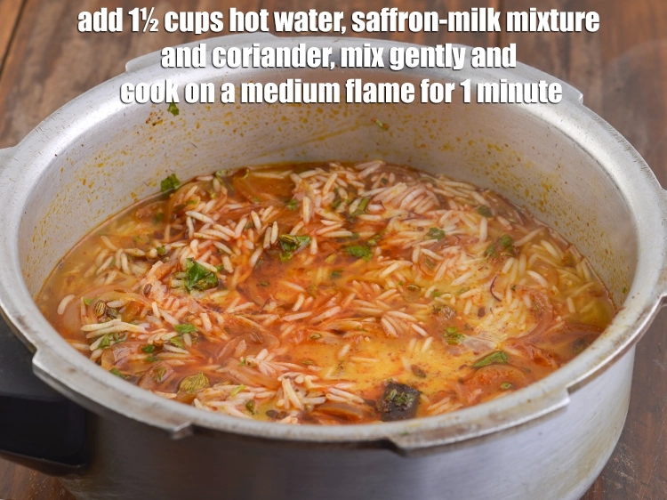 Step 14 – <p><span style="background-color:rgb(255,255,255);color:rgb(0,0,0);">Add 1½ cups <strong>hot water</strong>, <strong>saffron-milk mixture</strong> and 1 tbsp finely </span><a href="https://www.tarladalal.com/glossary-coriander-dhania-kothmir-369i#ing_2365"><u>chopped coriander …