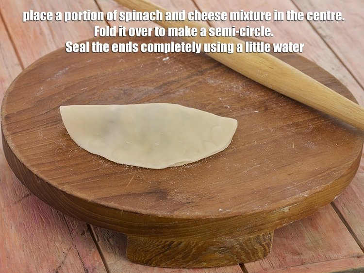 Step 7 – <p><span style="background-color:rgb(255,255,255);color:rgb(0,0,0);">Place a portion of <strong>spinach and cheese mixture</strong> in the centre. <strong>Fold </strong>it over …