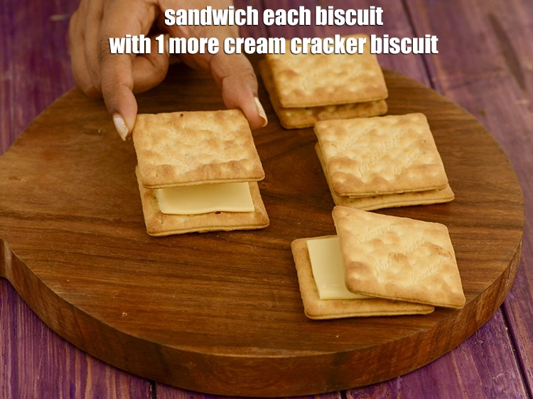 Step 7 – <p><strong>Sandwich</strong> each biscuit with 1 more <a href="https://www.tarladalal.com/glossary-cream-cracker-biscuit-206i"><u>cream cracker biscuit</u></a>.&nbsp;</p>