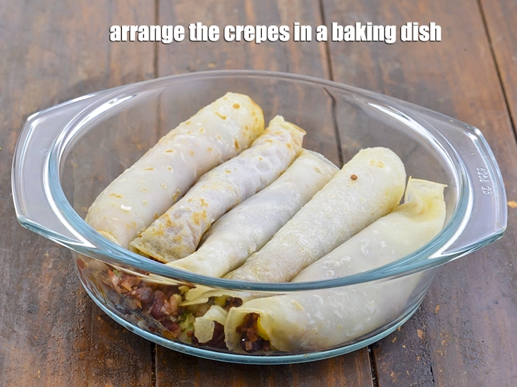 Step 13 – <p><span style="background-color:rgb(255,255,255);color:rgb(0,0,0);">Arrange the <strong>crepes</strong> in a baking dish.</span></p>