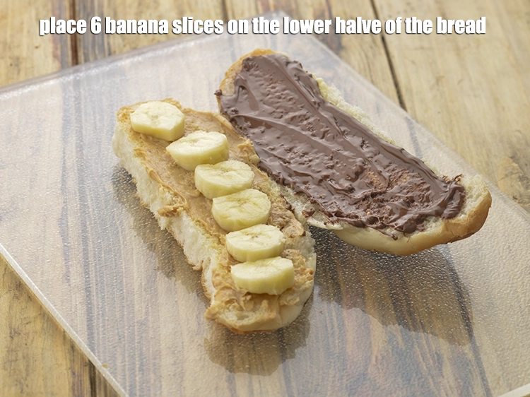 Step 6 – <p><span style="background-color:rgb(255,255,255);color:rgb(0,0,0);">Place 6 </span><a href="https://www.tarladalal.com/glossary-banana-kela-17i"><u>banana</u></a><span style="background-color:rgb(255,255,255);color:rgb(0,0,0);"> slices on the lower halve of the bread roll …