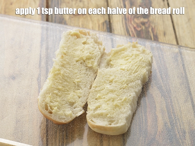 Step 18 – <p><span style="background-color:rgb(255,255,255);color:rgb(0,0,0);">Apply 1 tsp </span><a href="https://www.tarladalal.com/glossary-butter-makhan-233i"><u>butter</u></a><span style="background-color:rgb(255,255,255);color:rgb(0,0,0);"> on each halve of the <strong>bread roll</strong>.</span></p>