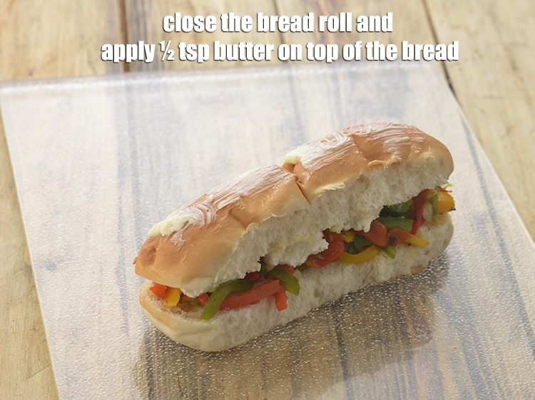 Step 20 – <p><span style="background-color:rgb(255,255,255);color:rgb(0,0,0);">Close the <strong>bread roll</strong> and apply ½ tsp </span><a href="https://www.tarladalal.com/glossary-butter-makhan-233i"><u>butter</u></a><span style="background-color:rgb(255,255,255);color:rgb(0,0,0);"> on top of …