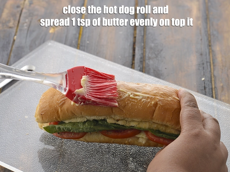 Step 5 – <p><span style="background-color:rgb(255,255,255);color:rgb(0,0,0);">Close the <strong>hot dog roll</strong> and spread 1 tsp of </span><a href="https://www.tarladalal.com/glossary-butter-makhan-233i"><u>butter</u></a><span style="background-color:rgb(255,255,255);color:rgb(0,0,0);"> evenly …