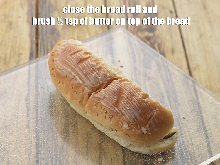 Step 12 – <p><span style="background-color:rgb(255,255,255);color:rgb(0,0,0);">Close the <strong>bread roll</strong> and brush ½ tsp of </span><a href="https://www.tarladalal.com/glossary-butter-makhan-233i"><u>butter&nbsp;</u></a><span style="background-color:rgb(255,255,255);color:rgb(0,0,0);"> on top …