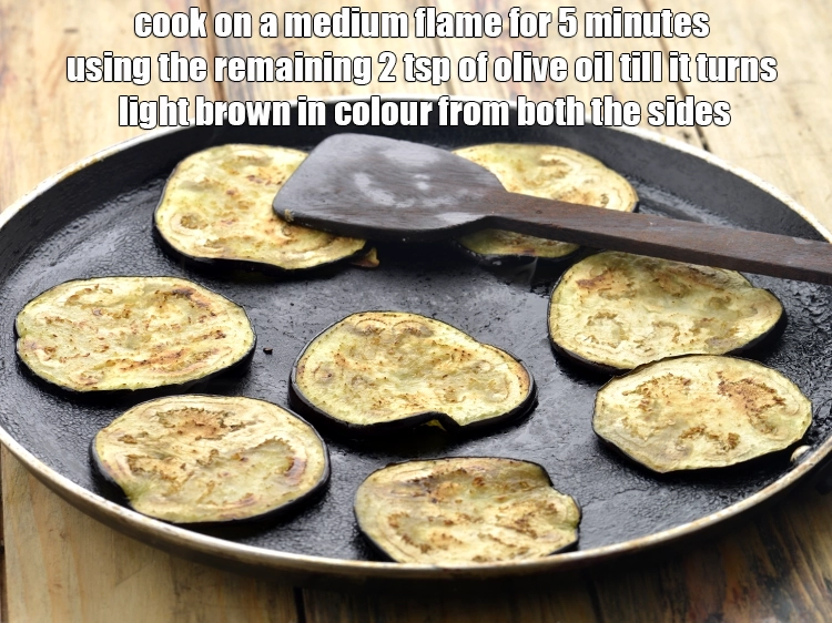 Step 5 – <p><span style="background-color:rgb(255,255,255);color:rgb(0,0,0);">Place the </span><a href="https://www.tarladalal.com/glossary-brinjal-baingan-eggplant-aubergine-128i#ing_2659"><u>brinjal (baingan / eggplant) slices</u></a><span style="background-color:rgb(255,255,255);color:rgb(0,0,0);"> on it and cook on …