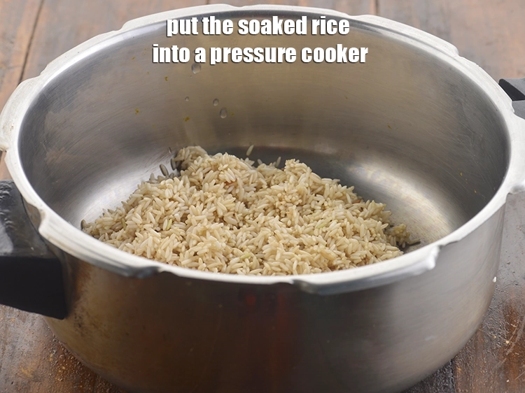 Step 5 – <p><span style="background-color:rgb(255,255,255);color:rgb(0,0,0);">Transfer the </span><a href="https://www.tarladalal.com/glossary-brown-rice-1618i#ing_2895"><u>brown rice</u></a><span style="background-color:rgb(255,255,255);color:rgb(0,0,0);"> into a pressure cooker.</span></p>