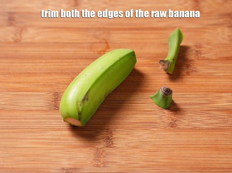 Step 3 – <p><span style="background-color:rgb(255,255,255);color:rgb(0,0,0);">Trim both the edges of the<strong> raw banana</strong>. Meanwhile, make light slits on the …