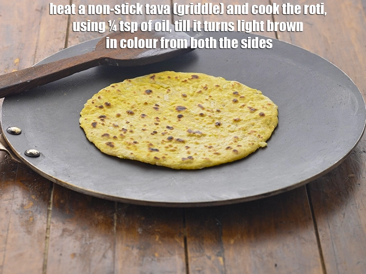 Step 6 – <p><span style="background-color:rgb(255,255,255);color:rgb(0,0,0);">Heat a non-stick tava (griddle) and cook the <strong>roti</strong>, using ¼ tsp of </span><a …