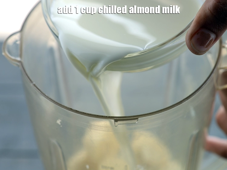Step 2 – <p>Add the <span style="background-color:rgb(255,255,255);color:rgb(0,0,0);">1 cup </span><a href="https://www.tarladalal.com/almond-milk-homemade-pure-almond-milk-40984r"><u>chilled almond milk</u></a><strong><u>.</u></strong></p>