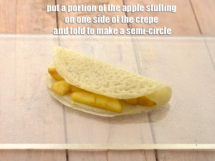 Step 18 – <p><span style="background-color:rgb(255,255,255);color:rgb(0,0,0);">Place a <strong>crêpes</strong> on a clean dry surface, put a portion of the <strong>apple …