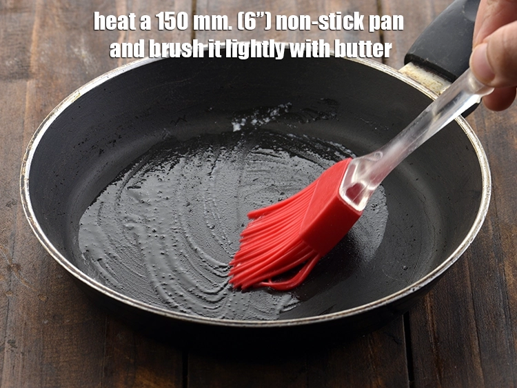 Step 9 – <p><span style="color:rgb(13,13,13);">Heat a 150 mm. (6”) non-stick pan and brush it lightly with </span><a href="https://www.tarladalal.com/glossary-butter-makhan-233i#ing_3123"><u>butter</u></a>.</p>