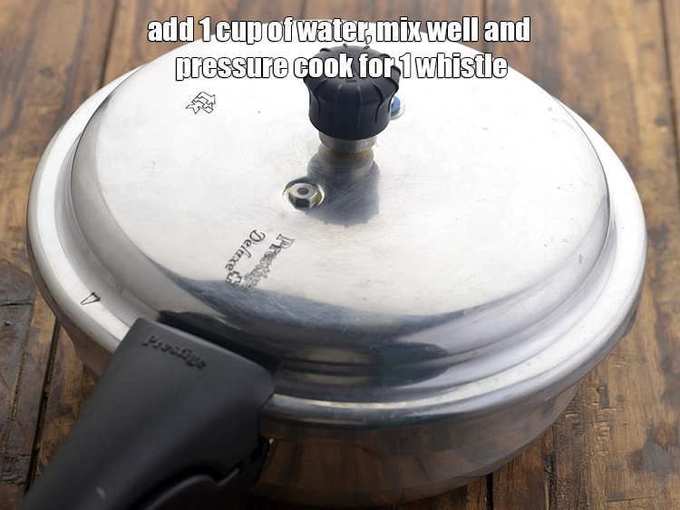 Step 2 – <p><span style="background-color:rgb(255,255,255);color:rgb(0,0,0);">Add 1 cup of <strong>water</strong>, mix well and pressure cook for 1 whistle.</span></p>