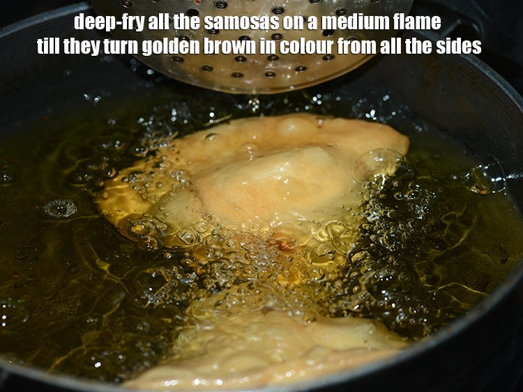 Step 20 – <p><span style="background-color:rgb(255,255,255);color:rgb(0,0,0);">Deep-fry all the <strong>samosas</strong> on a medium flame till they turn golden brown in …