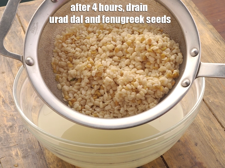 Step 16 – <p>After 4 hours, drain the urad dal and fenugreek seeds using a strainer. You can …