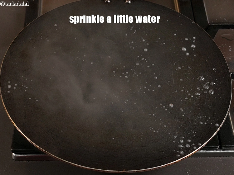 Step 30 – <p><span style="background-color:rgb(255,255,255);color:rgb(0,0,0);">Sprinkle a little water on the tava (griddle). The temperature of the tawa should …