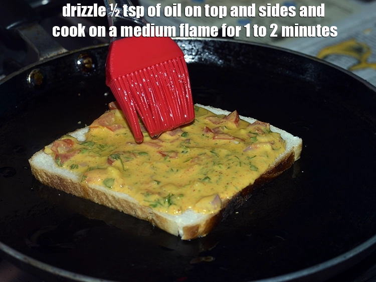 Step 14 – <p><span style="background-color:rgb(255,255,255);color:rgb(0,0,0);">Drizzle ½ tsp of </span><a href="https://www.tarladalal.com/glossary-oil-671i"><u>oil&nbsp;</u></a><span style="background-color:rgb(255,255,255);color:rgb(0,0,0);"> on top and sides and cook on …