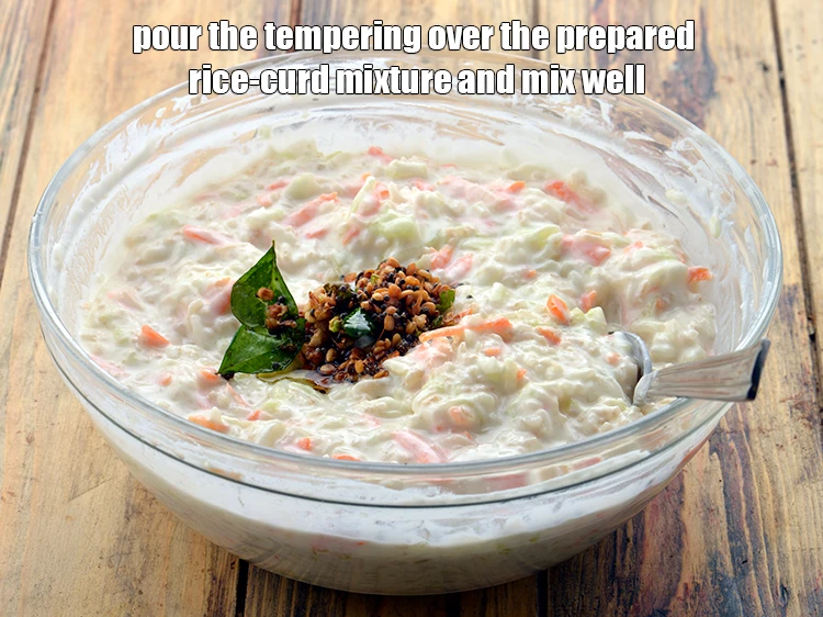 Step 8 – <p><span style="background-color:rgb(255,255,255);color:rgb(0,0,0);">Pour the tempering over the prepared rice-curd mixture and mix well.</span></p>