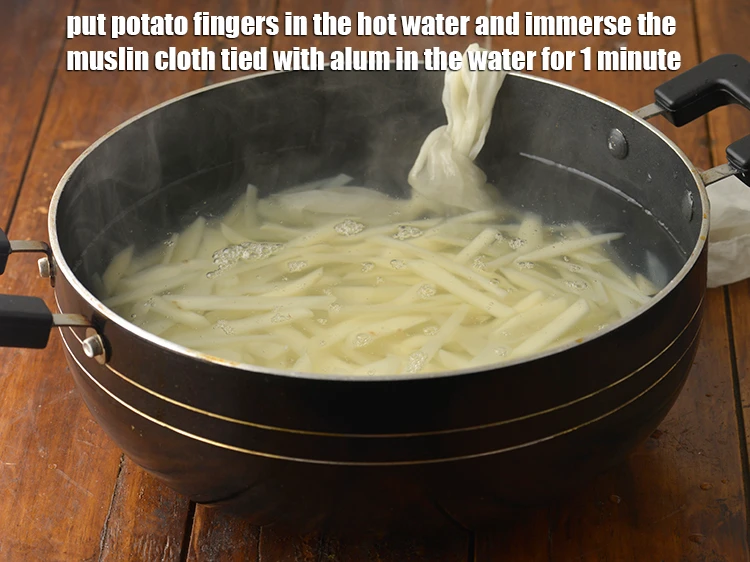 Step 3 – <p><span style="background-color:rgb(255,255,255);color:rgb(0,0,0);">Put the thin </span><a href="https://www.tarladalal.com/glossary-potatoes-aloo-alu-batata-710i#ing_2427"><u>potato fingers</u></a><span style="background-color:rgb(255,255,255);color:rgb(0,0,0);"> in the <strong>hot water</strong> and immerse the …