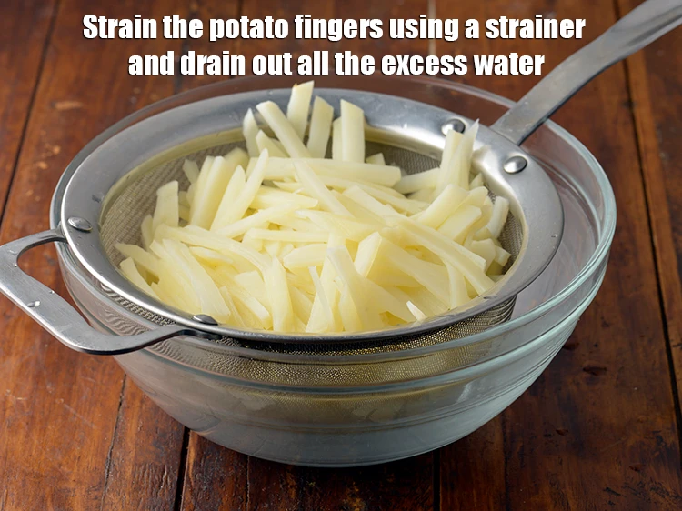 Step 5 – <p><span style="background-color:rgb(255,255,255);color:rgb(0,0,0);">Strain the <strong>potato fingers</strong> using a strainer and drain out all the excess water.</span></p>