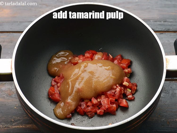 Step 21 – <p><span style="background-color:rgb(255,255,255);color:rgb(0,0,0);">Add 1/4 cup&nbsp;</span><a href="https://www.tarladalal.com/glossary-tamarind-pulp-tamarind-extract-imli-ka-pulp-838i"><u>tamarind (imli) pulp</u></a><span style="background-color:rgb(255,255,255);color:rgb(0,0,0);">. This gives a very nice sourness.</span></p>