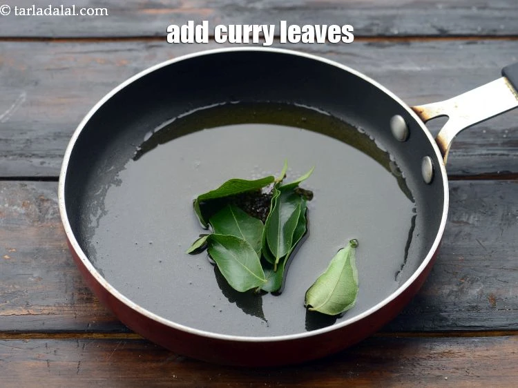 Step 32 – <p><span style="background-color:rgb(255,255,255);color:rgb(0,0,0);">Add&nbsp;6 to 7&nbsp;</span><a href="https://www.tarladalal.com/glossary-curry-leaves-kadi-patta-kadipatta-388i"><u>curry leaves (kadi patta)</u></a><span style="background-color:rgb(255,255,255);color:rgb(0,0,0);">.</span></p>