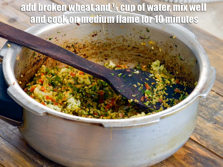 Step 4 – <p><span style="background-color:rgb(255,255,255);color:rgb(0,0,0);">Add the 1/2 cup </span><a href="https://www.tarladalal.com/glossary-broken-wheat-dalia-bulgur-wheat-lapsi-fada-426i"><u>broken wheat (dalia)&nbsp;</u></a><span style="background-color:rgb(255,255,255);color:rgb(0,0,0);"> and ¼ cup of <strong>water</strong>, …