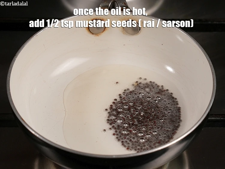 Step 18 – <p><span style="background-color:rgb(255,255,255);color:rgb(0,0,0);">Add the 1/2 tsp </span><a href="https://www.tarladalal.com/glossary-mustard-seeds-sarson-rai-sarson-ke-beej-525i"><u>mustard seeds ( rai / sarson)</u></a><span style="background-color:rgb(255,255,255);color:rgb(0,0,0);">.</span></p>
