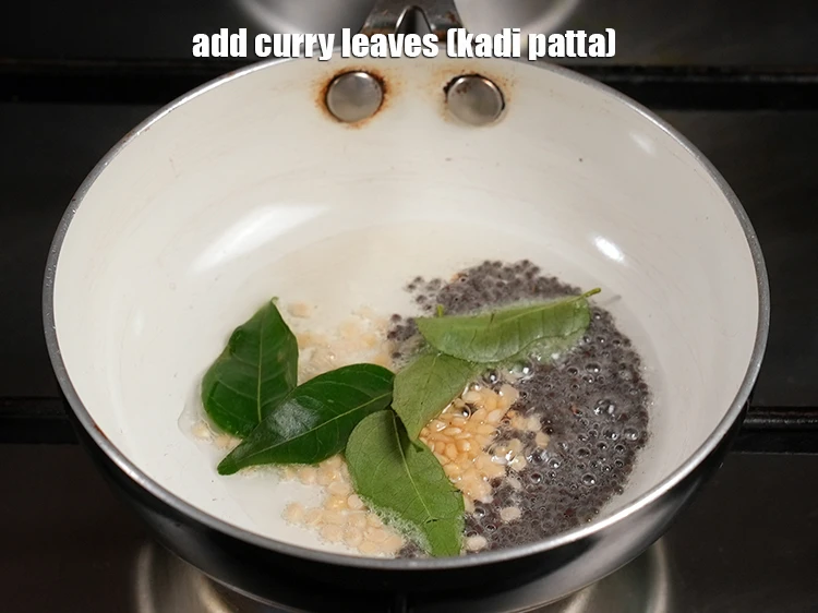 Step 20 – <p><span style="background-color:rgb(255,255,255);color:rgb(0,0,0);">Add the 8 </span><a href="https://www.tarladalal.com/glossary-curry-leaves-kadi-patta-kadipatta-388i"><u>curry leaves (kadi patta)</u></a><u>.</u></p>
