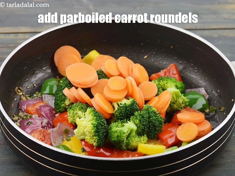 Step 16 – <p>&nbsp;Add ½ cup parboiled <a href="https://www.tarladalal.com/glossary-carrot-roundels-2352i">carrot roundels</a>.</p>
