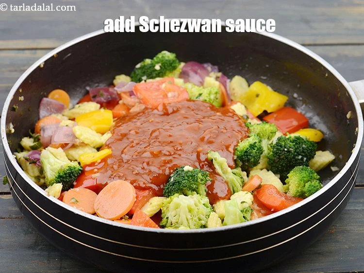 Step 19 – <p>Add ½ cup <a href="https://www.tarladalal.com/glossary-Schezwan-sauce-Schezuan-sauce-1872i">schezwan sauce</a>.</p>