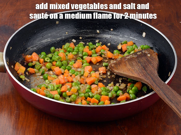 Step 2 – <p><span style="background-color:rgb(255,255,255);color:rgb(0,0,0);">Add the 1 1/2 cups </span><a href="https://www.tarladalal.com/glossary-mixed-vegetables-mixed-sabzi-723i#ing_2423"><u>boiled mixed vegetables</u></a><span style="background-color:rgb(255,255,255);color:rgb(0,0,0);"> and </span><a href="https://www.tarladalal.com/glossary-salt-namak-table-salt-418i"><u>salt</u></a><span style="background-color:rgb(255,255,255);color:rgb(0,0,0);"> …